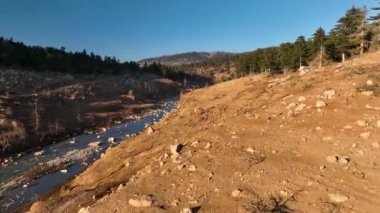 Smooth drone flight in the mountains, beautiful sunset light