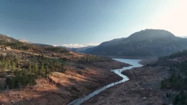 Beautiful landscape of a small village on the banks of a mountain river aerial view