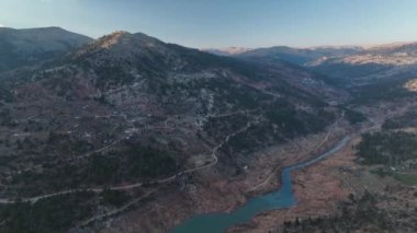 Beautiful landscape of a small village on the banks of a mountain river aerial view