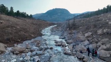 Water swiftly beats stones aerial view smooth frame 4 K