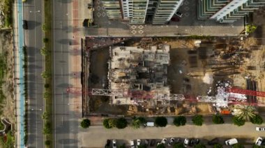 Construction site on the shores of the Mediterranean Sea, a crane lifts the metal structure 4 K