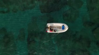 fishing near the shore in his small boat 4K