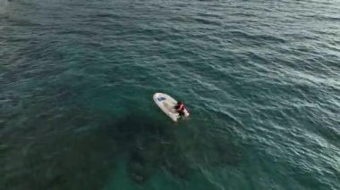 fishing near the shore in his small boat 4K