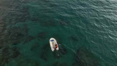 fishing near the shore in his small boat 4K