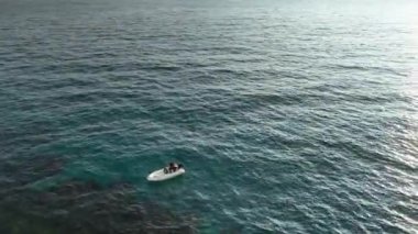 Old fisherman spreads his fishing nets in the sea, near the shore aerial view background