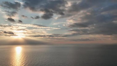 Beautiful sunset with colorful yellow and blue cloudy sky. fky above awesome sea