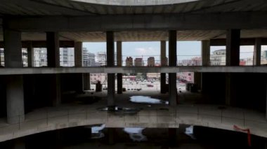 Old unfinished mall, empty space, bare concrete, aerial view. 4K aerial view
