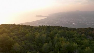 Aerial View Of Foggy Valley Expanse Behind Sloping Mountain Pass In Summer