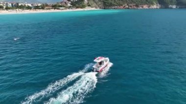 Büyük balıklarla uçan bir balıkçı teknesi. Dönen aç martılar. Havadan seyyar dron sürüsü. Deniz yüzeyinde yüzen küçük bir gemi, deniz köpüğü sularından oluşan bir yol bırakır. Üst görünüm