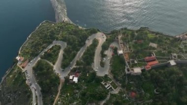 Ufuktaki deniz manzarasının destansı manzarası dağdaki virajlı bir yol büyük bir parka götürür.