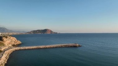 Sunny day on the Cleopatra beach. harbor of Alanya and Cleopatra beach, Antalya, Turkey. Alanya beach top view on the mountain with coast on blue sea and harbor city background