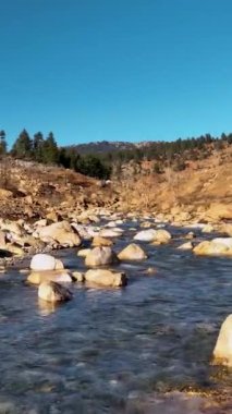 Bir nehrin rahatlatıcı serenatı, bu dikey videoyla duyularınızı cezbetsin. Yumuşak suları yakalasın ve manzara boyunca şarkı söylesin. Huzurlu ortamı hisset ve doğayla bağlantı kur.