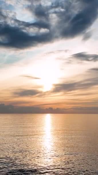 海に沈む夕日の魅惑的な美しさにあなたの感覚を浸します 太陽の光に照らされた深い青色の海の魅惑的な色のグラデーションと絶妙な質感を体験してください — ストック動画