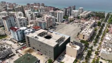 İnşaat alanının üstünde süzül ve ticari tesisin çatısını su geçirmez hale getirmek için hazırlayan işçilere havadan bir bakış at..