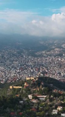 Alanyas antik kalesinin üzerinde süzülür ve bu dikey videoda büyüleyici panoramik manzarayı yakalayan Akdeniz kıyılarını ele alır..