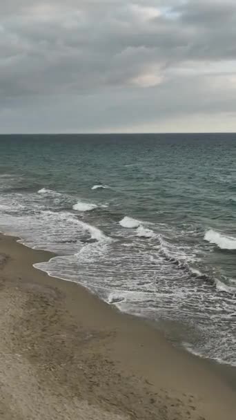 地中海の美しいビーチで魔法の夕日を見ながら映画の冬の波に身を浸し 人々を散歩させ この冬の雰囲気を楽しんでください — ストック動画