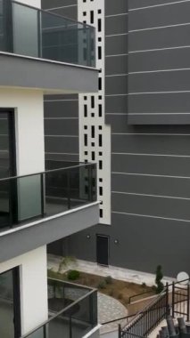 İnsansız hava aracı bu büyüleyici dikey videoda tamamlanmış çalışmaları incelerken yeni inşa edilmiş bir konut kompleksine kuşbakışı bakın.