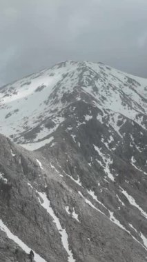 Karlı tepelerin yemyeşil ormanlarla buluştuğu bir dağ vadisinde manzaralı bir hava yolculuğuna çıkın. Manzaranın doğal güzelliği, dikey videonuzu büyülesin..