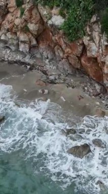 Terkedilmiş bir Akdeniz sahilinde huzur bul. Gök mavisi dalgalar yavaşça kayalık kıyılara çarpıyor..