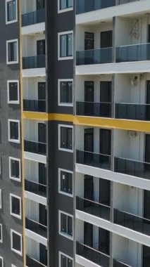 Ön cephe çalışması ve pencere kurulumu da dahil olmak üzere çok katlı bir binanın yapımına dikkat edin.