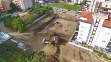 İnşaat alanında çalışan ağır makinelerin 4K hava görüntülerinin keyfini çıkarın. Dinamik ve meşgul.