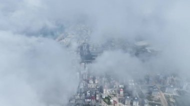 Bulutların arasından kırılan şehir manzarasına bakın, yukarıdan çarpıcı bir hava manzarası sunuyor..