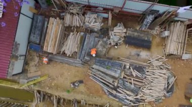 İnşaat alanındaki büyük bir binanın temellerine beton döşeyen işçilere bakın.