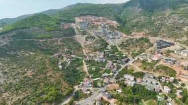 İnsansız hava aracı yaz aylarında gökyüzünde gezinirken şehir manzarasının ışıltısını keşfedin..