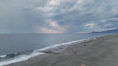 Bulutlu bir günbatımının büyüleyici insansız hava aracı görüntüleri Akdeniz 'in üzerine mavi renkler döküyor.