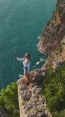 Manken gibi nefes kesen bir deniz manzarası bir uçurumda güven içinde duruyor..