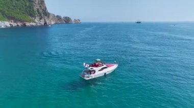 İnsanların su sporlarından ve oyunlardan zevk aldığı güzel beyaz bir Akdeniz plajı..