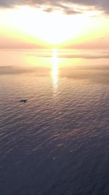 Sakin sular ve limana giden bir tekne gibi parlayan bir gökyüzü..