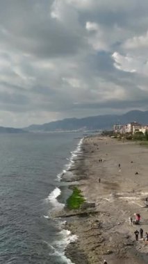 Berrak mavi su, sakin bir ortamda taşların üzerinde dokular oluşturuyor..