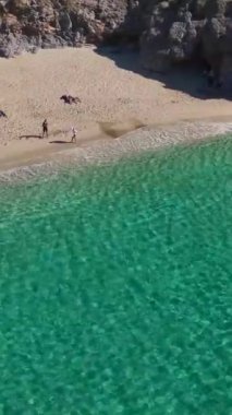 Beyaz kumda hafif dalgalar. Güzel ve sakin bir sahil sahnesinin hava görüntüleri..