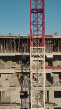 Beton dökme ve vinç kaldırma devam ediyor. Dinamik ve yetenekli bir inşaat alanının hava görüntüleri.