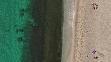 Gün doğumunda, parlak mavi sular ve yumuşak beyaz kumların sabah 6 'da sakin bir sahil manzarası yarattığı bir kumsalda sürükleniriz.