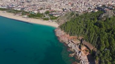 Okyanusun nefes kesici manzarası ve çevresindeki manzarayla, yüksek bir uçurumun üzerindeki ortaçağ kalesinin havadan çekilmiş görüntüsü..