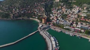 Alanya 'nın kırmızı kulesine hayran olun, taş duvarlar ve nefes kesici dağ ve deniz manzarası sonsuz bir manzara yaratır..