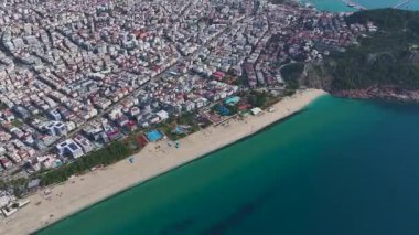 Beyaz sahil, mavi dalgalar ve ufuk çizgisi. Rahatlatıcı bir tatil yerinin hava görüntüleri..