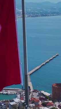 Ulusal bayrak ve ortaçağ kalesi. Barışçıl bir mirasın dikey görüntüsü.