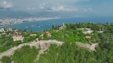 Mosque, lighthouse, and vessels at bay entrance.