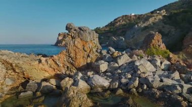 Deniz kenarındaki kayalık sahildeki evlerin insansız hava aracı görüntüleri..