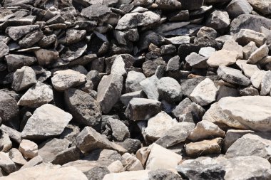 Texture of a stone wall with many big brown and grey stones armed with cement. Old castle stone wall texture background for medieval usage. Part of a stony building as a background