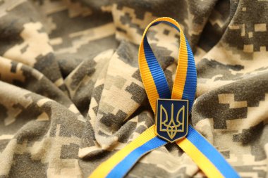 Pixeled digital military camouflage fabric with ukrainian flag and coat of arms on stripes ribbon in blue and yellow colors. Attributes of ukrainian soldier uniform clipart