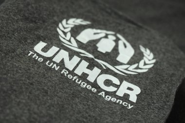 KYIV, UKRAINE - MAY 4, 2022 UNHCR The UN Refugee Agency logo on humanitarian grey blankets from humanitarian aid goods clipart