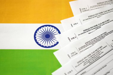 KYIV, UKRAINE - MAY 4, 2022 Indian income tax return blank forms on indian country flag close up. Annual tax report concept