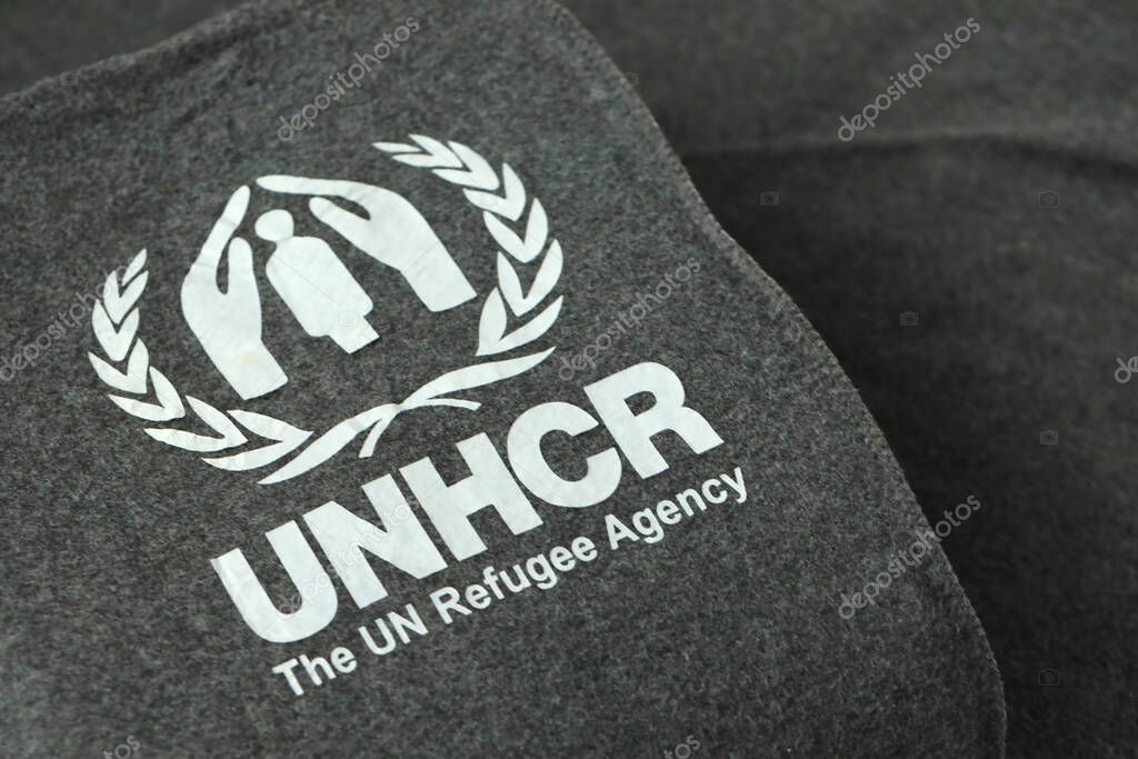 KYIV, UKRAINE - MAY 4, 2022 UNHCR The UN Refugee Agency logo on humanitarian grey blankets from humanitarian aid goods