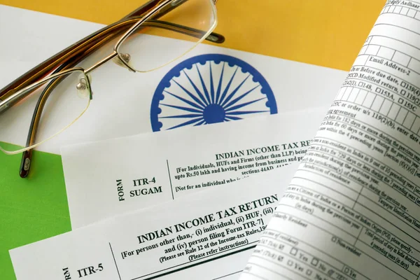 stock image KYIV, UKRAINE - MAY 4, 2022 Indian income tax return blank form with pen and indian rupees bills on indian country flag close up. Annual tax report concept