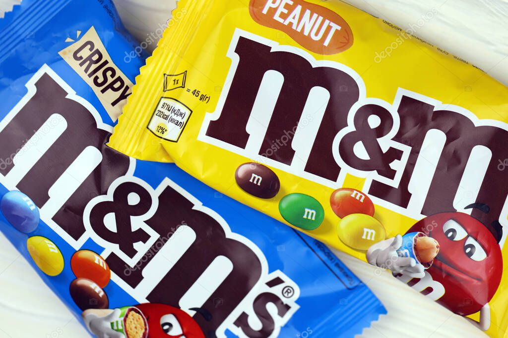 KHARKIV, UKRAINE - JANUARY 2, 2021 M and Ms colorful button shaped chocolate candies. Multi colored chocolates each of which has the letter m printed in lower case in white on one side
