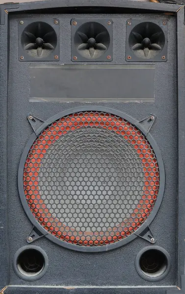 Old used audio speaker texture on dark blue background